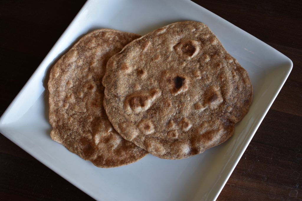 Two roti/chapati Indian style flatbread on a plate