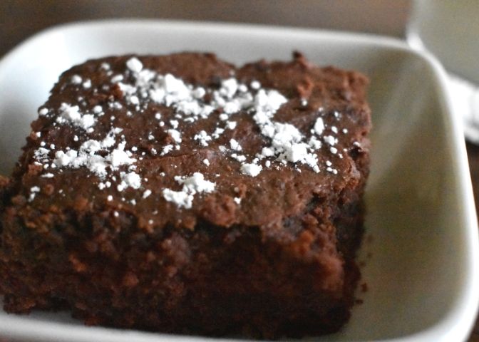 Peanut butter black bean brownie with milk in background