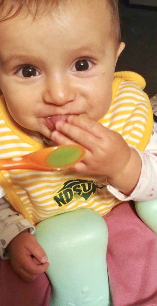 baby eating homemade peas