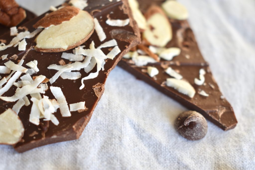 Closeup of easy chocolate bark with coconut, almonds, pecans, and sea salt